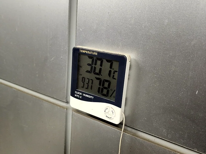 지식산업센터 실외기실 열기 점검 중 30.7도를 가리키는 온습도계